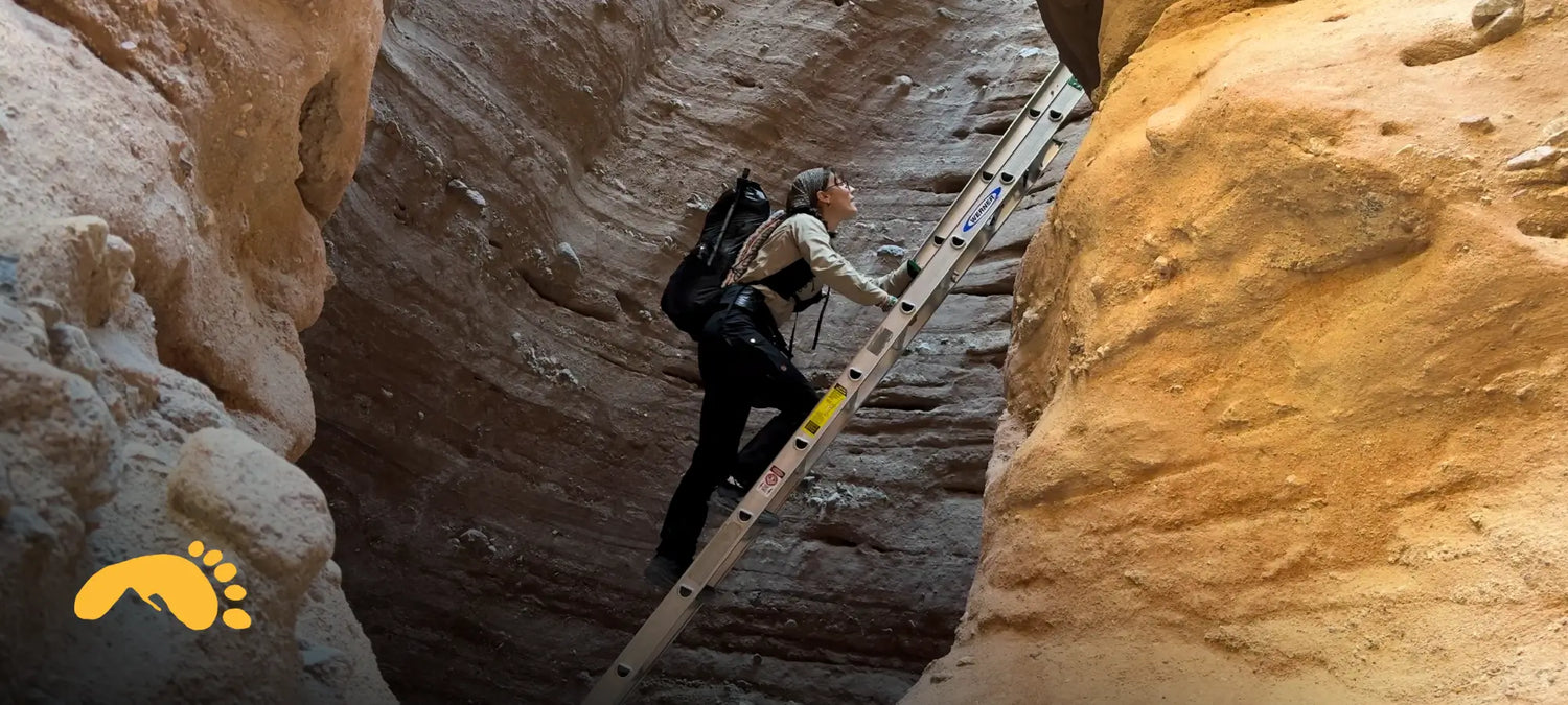 Pepper climbing up a ladder in a slot canyon on a solo backpacking trip somewhere in Southern California