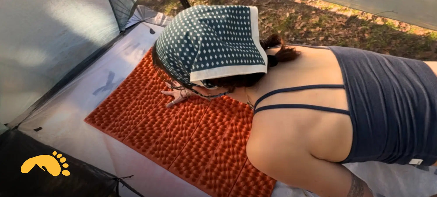 Pepper hunched over her newly sized sleeping pad, becoming an Ultralight Backpacker!