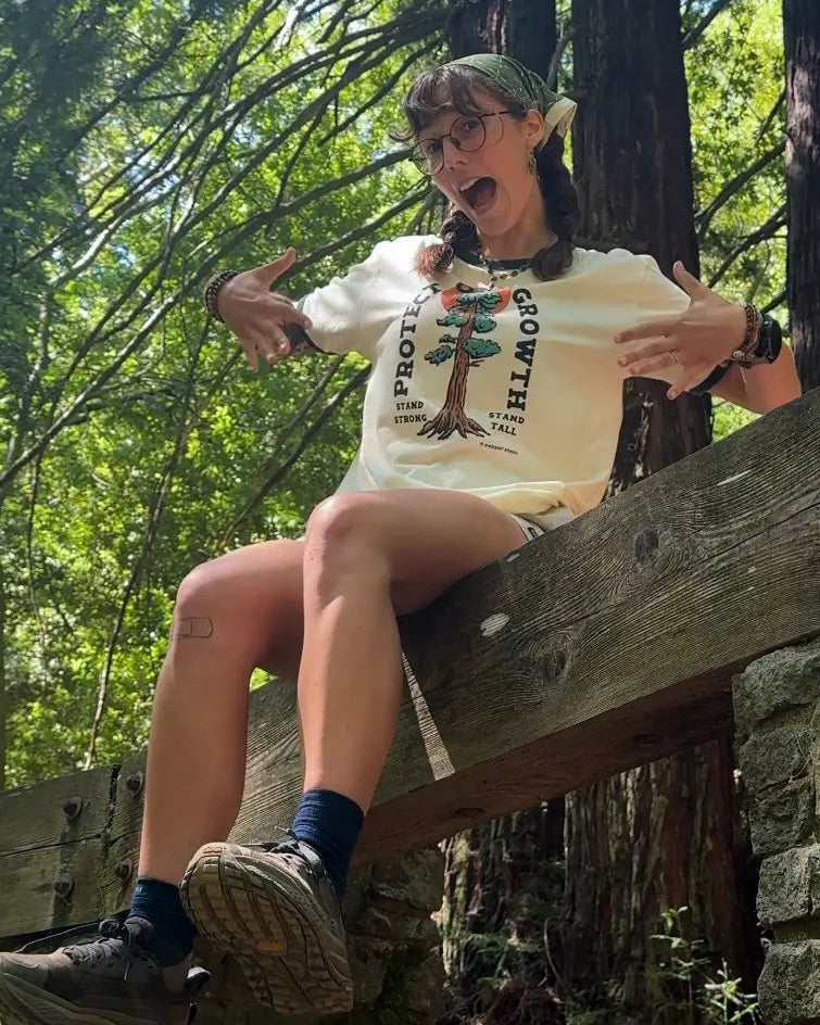 Person sitting on a wooden bench in a forest